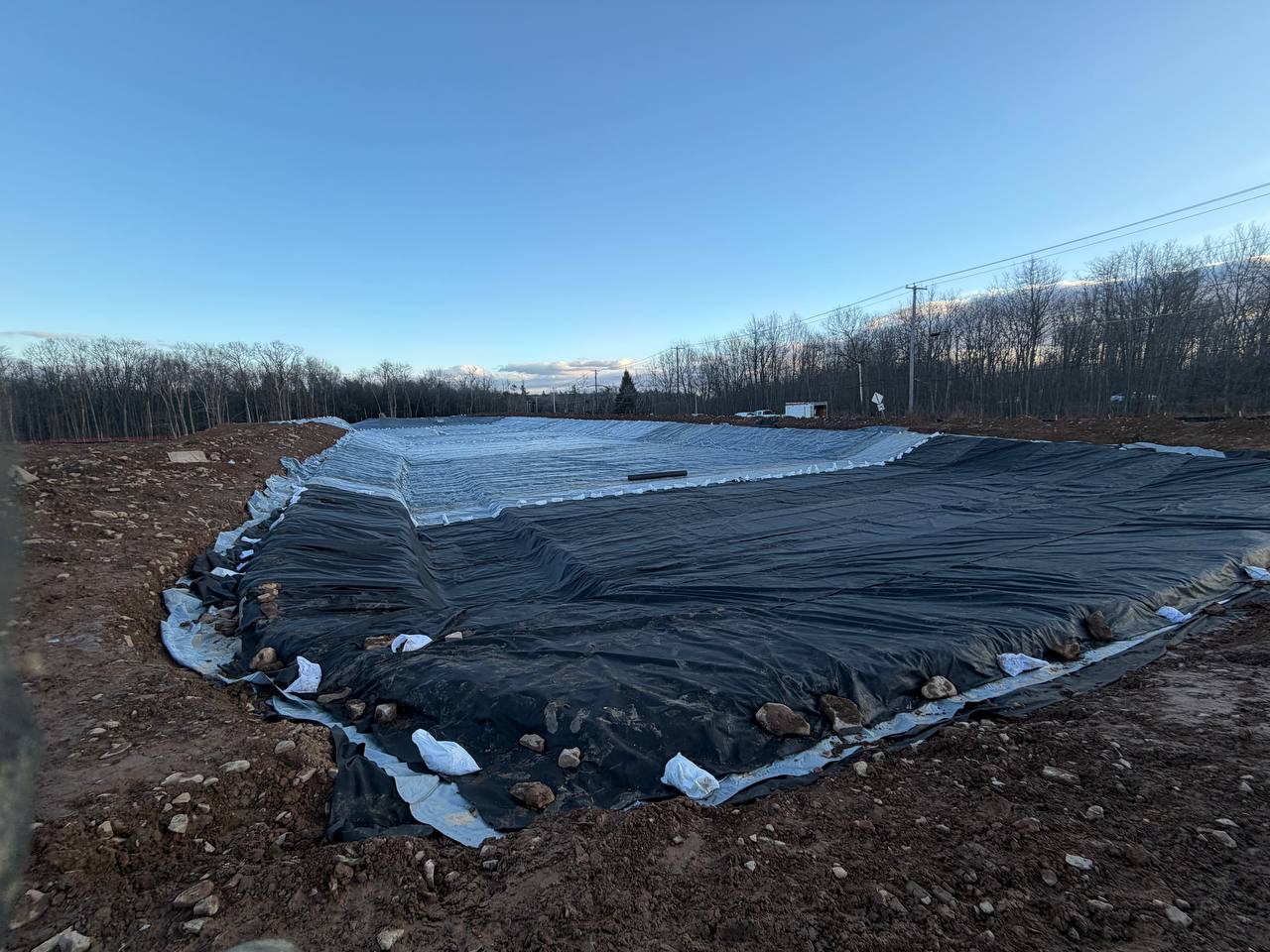 Geomembrane liner anchored with sandbags